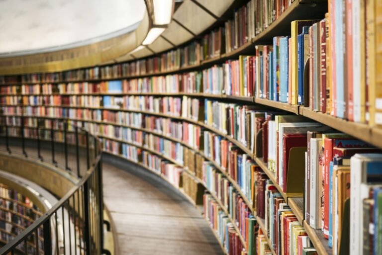 Open history book and archival documents representing the study of wartime history